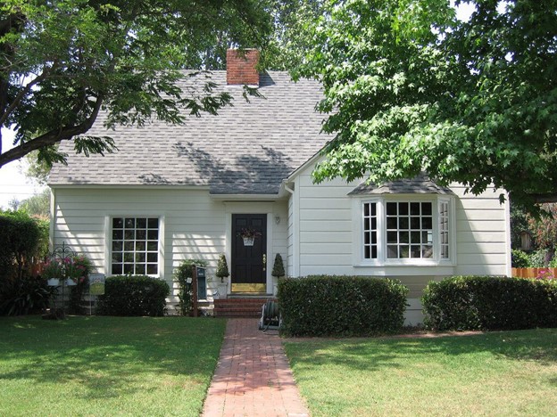 White suburban home in Upland, CA, featuring new grid-pattern replacement windows that enhance light and curb appeal.