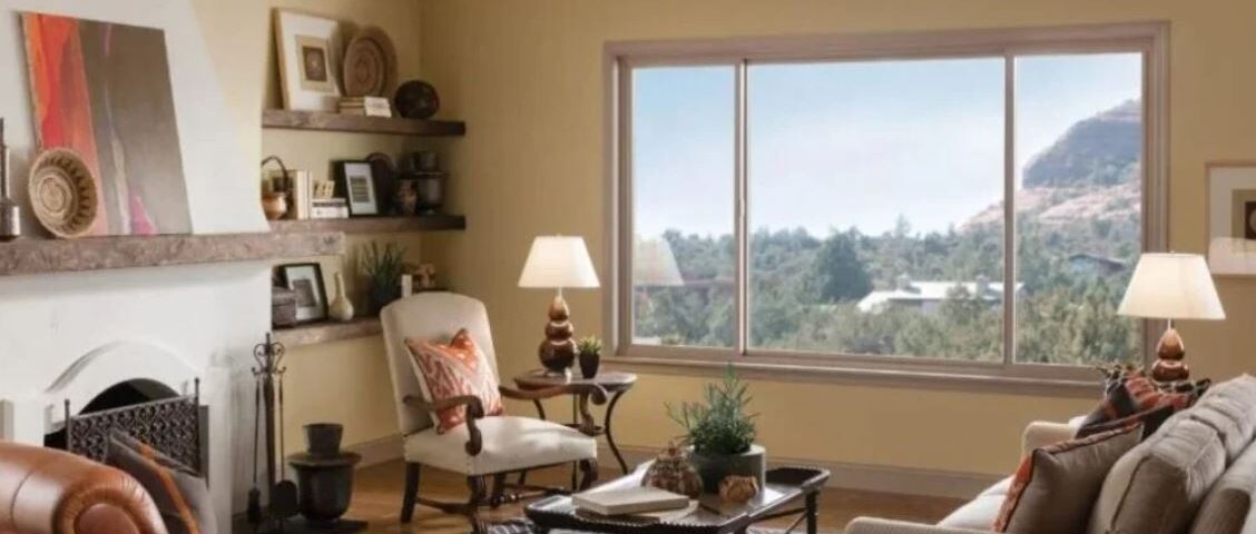 large three-panel window with a clear view of trees and a hillside
