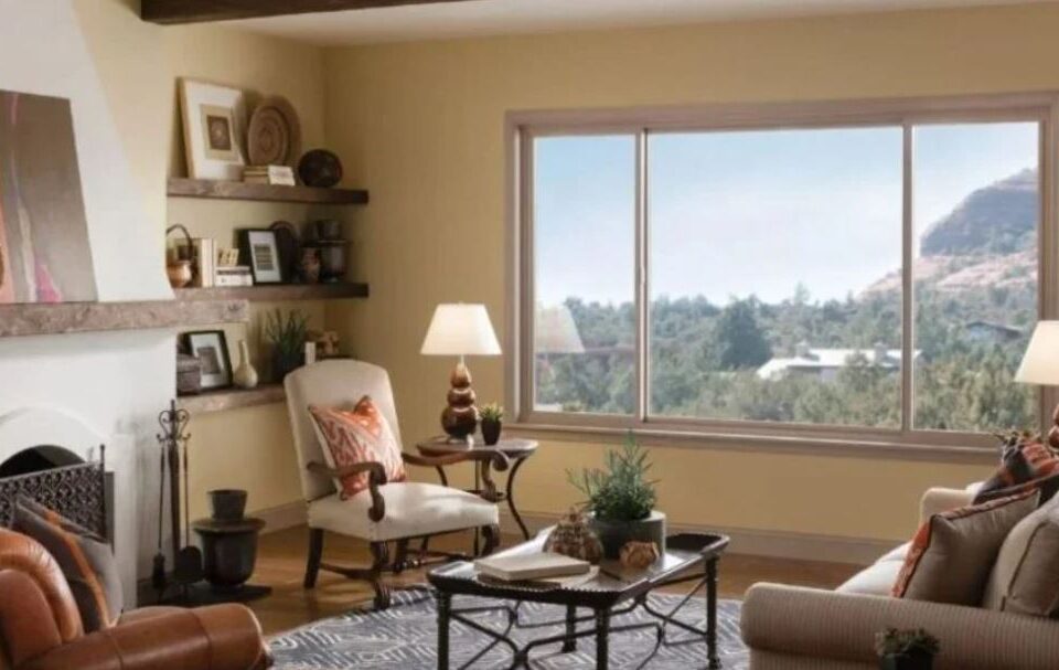 large three-panel window with a clear view of trees and a hillside