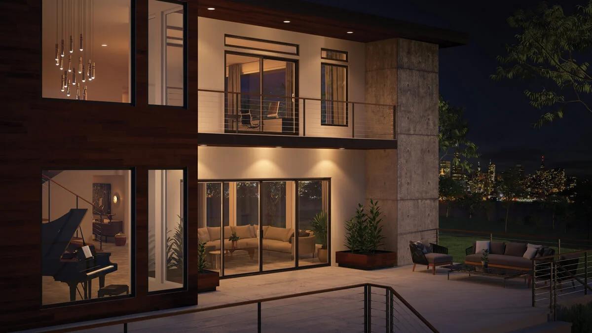 Modern two-story home at night with expansive glass walls and sliding patio doors showcasing stylish replacement windows and doors Corona, CA, enhancing energy efficiency and contemporary curb appeal.