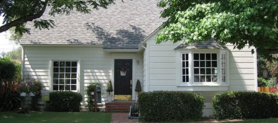 white bay window with multiple panes on the front of a small house