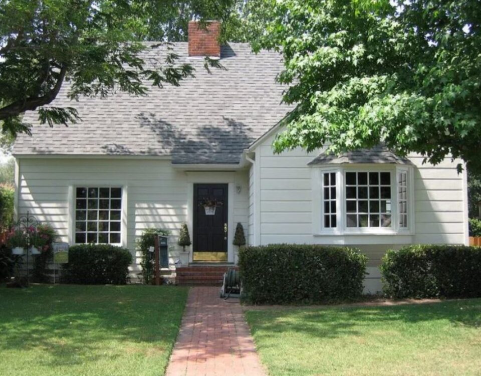 white bay window with multiple panes on the front of a small house