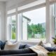 Modern living room with large replacement windows and Roman shades in Corona, CA