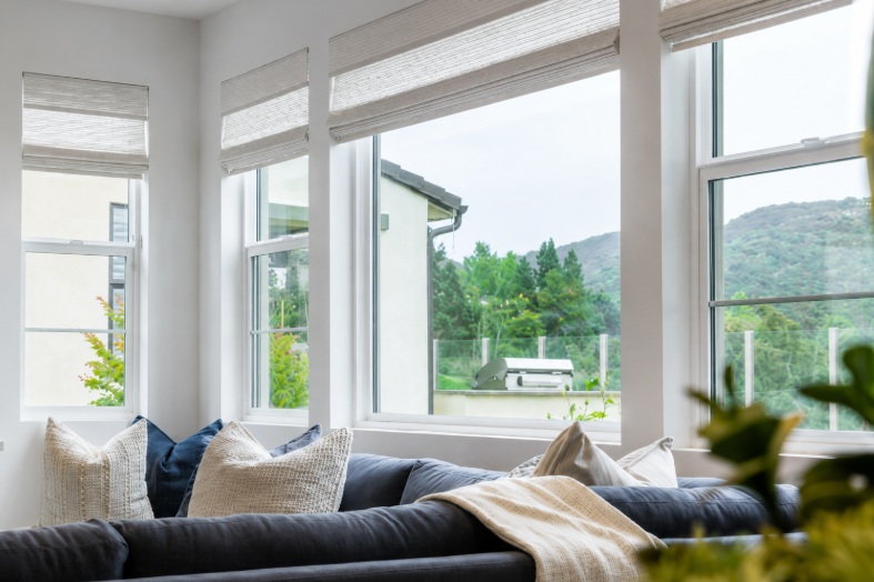 Modern living room with large replacement windows and Roman shades in Corona, CA
