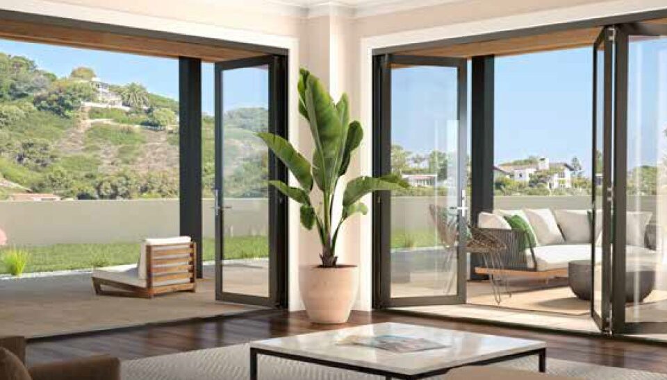 Folding patio doors with wide glass panels complement Ontario, CA windows in a modern home